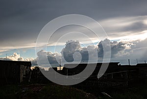 Beautiful clouds in the blue sky over the village, nature background in summer