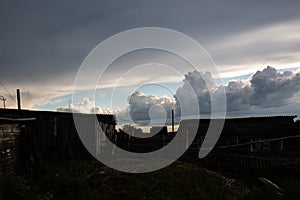 Beautiful clouds in the blue sky over the village, nature background in summer