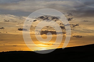 Beautiful clouds over the green meadow during sunrise or sunset.