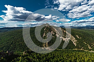 Beautiful clouds over the green mountain. Maly Yamantau Mountain in Bashkiria, Russia. A green forest under a blue sky. Forest