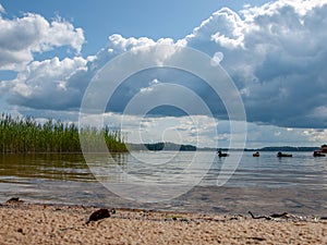 Beautiful clouds over lake in summer sunny day with reflections