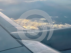 Beautiful clouds and sky at sunset as seen through window of an aircraft - Airplane window - natural shot