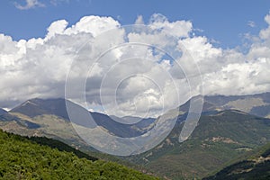 Beautiful cloudscape over a forested mountain range