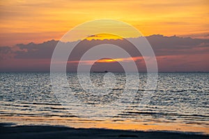 Beautiful cloudscape over the sea, scenic dramatic golden sunset