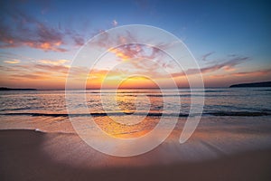 Beautiful cloudscape over the sea waves and beach at sunrise, sunset seascape nature