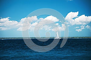 Beautiful cloudscape and sailing catamaran in the carribean sea