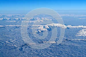 Beautiful cloudscape and snow mountains from plane window