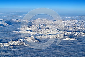 Beautiful cloudscape and snow mountains from plane window