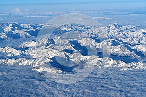 Beautiful cloudscape and snow mountains from plane window