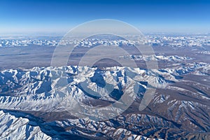 Beautiful cloudscape and snow mountains from plane window