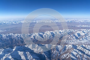 Beautiful cloudscape and snow mountains from plane window