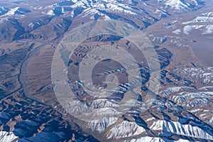 Beautiful cloudscape and snow mountains from plane window