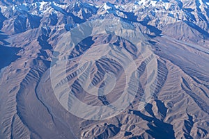 Beautiful cloudscape and snow mountains from plane window