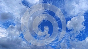 Beautiful cloudscape with soft white formations floating over a bright blue sky.