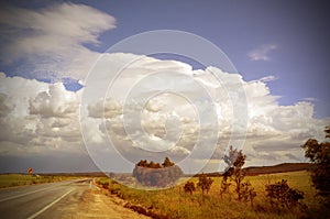 Beautiful cloudscape and storm over road through countryside