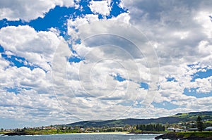 Beautiful cloudy sky above green city hill of Kiama, New South Wales, Australia.