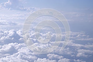 Beautiful cloudy sky from aerial view background. Airplane view above clouds. Sky and cloud texture