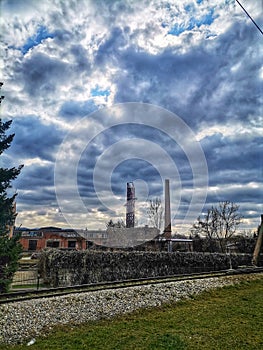 Beautiful cloudy sky, industrial chimneys, railroad