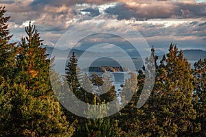 Beautiful cloudy sunset view of the lake Nahuel Huapi, its islands and mountains in the background, surrounded by