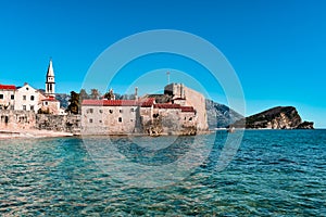 Beautiful coast and the old town of Budva, Montenegro. Adriatic sea water, blue sky