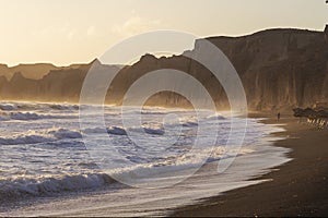 Beautiful coast at sunrise Vlychada beach on Santorini island in Greece. On the background of the sea is a blue sky with the