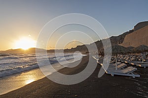 Beautiful coast at sunrise Vlychada beach on Santorini island in Greece. On the background of the sea is a blue sky with the