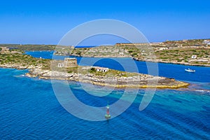 Beautiful coastline Balearis Minor with azure color of the sea and blue sky, serving peninsula with old buildings, top view, Spai