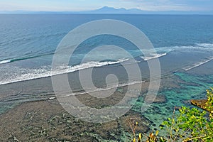 Beautiful coastline with volcanic mountains at the background. Bali, Indonesia