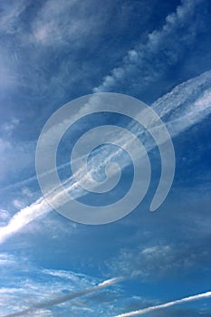 Beautiful cobalt blue skies with streaks from jet airplanes