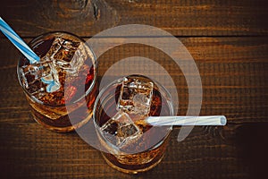 Beautiful cold fizzy cola soda with cubes ice