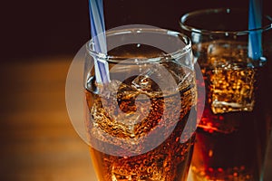 Beautiful cold fizzy cola soda with cubes ice