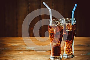 Beautiful cold fizzy cola soda with cubes ice