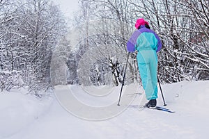 Beautiful cold forest view of ski run track on ski resort, winter day on a slope, pist, nordic skier on the track in winter,