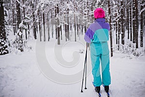 Beautiful cold forest view of ski run track on ski resort, winter day on a slope, pist, nordic skier on the track in winter,