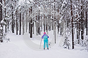 Beautiful cold forest view of ski run track on ski resort, winter day on a slope, pist, nordic skier on the track in winter,