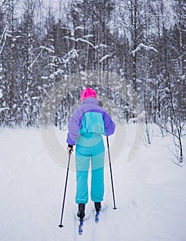 Beautiful cold forest view of ski run track on ski resort, winter day on a slope, pist, nordic skier on the track in winter,