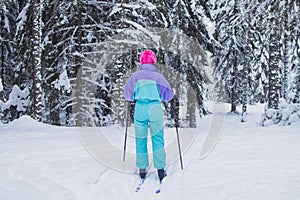 Beautiful cold forest view of ski run track on ski resort, winter day on a slope, pist, nordic skier on the track in winter,