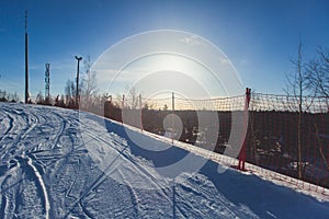 Beautiful cold mountain view of ski resort, sunny winter day with slope, piste and ski lift, with group of mountain downhill