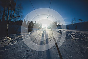 Beautiful cold mountain view of ski resort, sunny winter day with slope, piste and ski lift, with group of mountain downhill