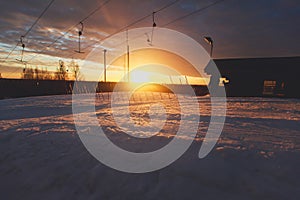 Beautiful cold mountain view of ski resort, sunny winter day with slope, piste and ski lift, with group of mountain downhill