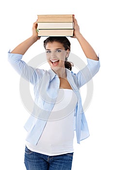 Beautiful college student holding books smiling