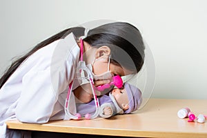 Beautiful Colombian girl plays a pediatrician doctor examining her toys