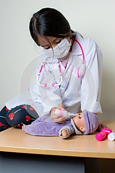 Beautiful Colombian girl plays a pediatrician doctor examining her toys