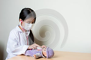 Beautiful Colombian girl plays a pediatrician doctor examining her toys