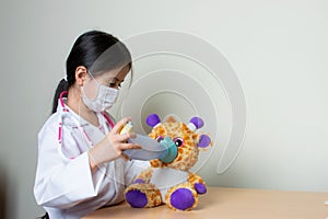 Beautiful Colombian girl plays a pediatrician doctor examining her toys