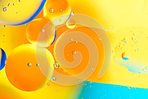 Beautiful color abstract background from mixied water and oil. Pastel colored abstraction. Yellow and blue background from water b