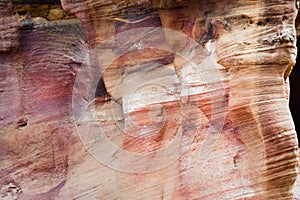 Beautiful color texture pink orange red yellow white color geological rock formations in city of Petra in Jordan