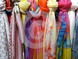 Beautiful Colored woman's scarves tied knot to the rack .