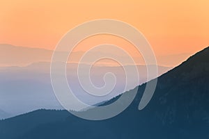 A beautiful, colorful, abstract mountain scenery in sunrise. Minimalist landscape of mountains in morning in blue tones.