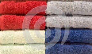 Beautiful colorful bath towels tidily folded on shelves in department store used as pattern background